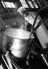 beautiful black and white photo of a chef and a giant pot